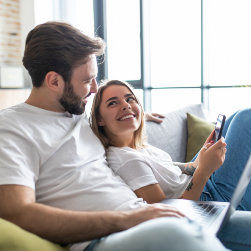 Couple reading an online article together on a mobile device.