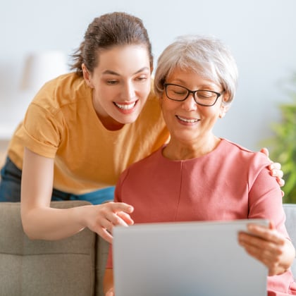 Grandmother and daughter reading together.