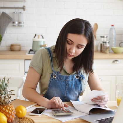 A woman calculating her finances.