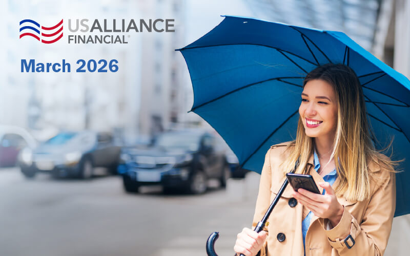 USAlliance logo, March 2026 with a woman outside standing with an umbrella.