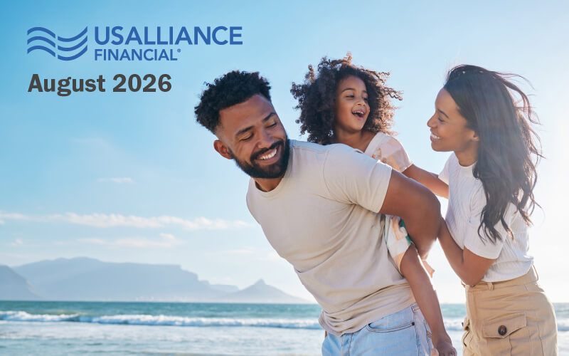 A family smiling on the beach with the USALLIANCE logo and "August 2026" written on top.