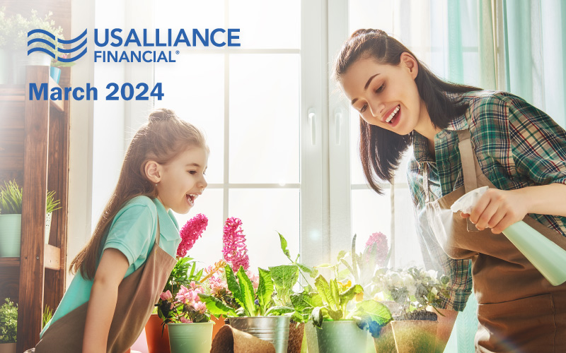 Mother and daughter enjoying time together watering plants.