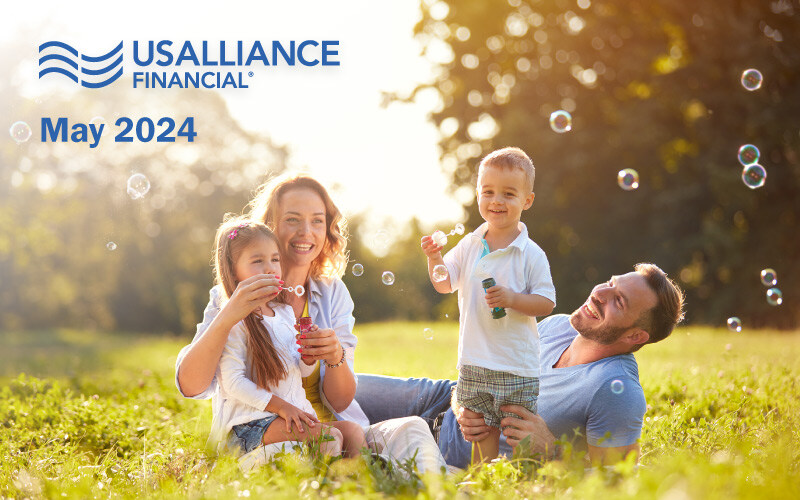 USALLIANCE FINANCIAL, May 2024 Newsletter. Happy family enjoying a day in the park blowing bubbles. 