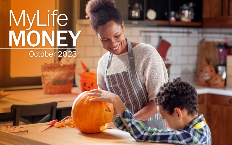 Mother and son craving a pumpkin in the kitchen