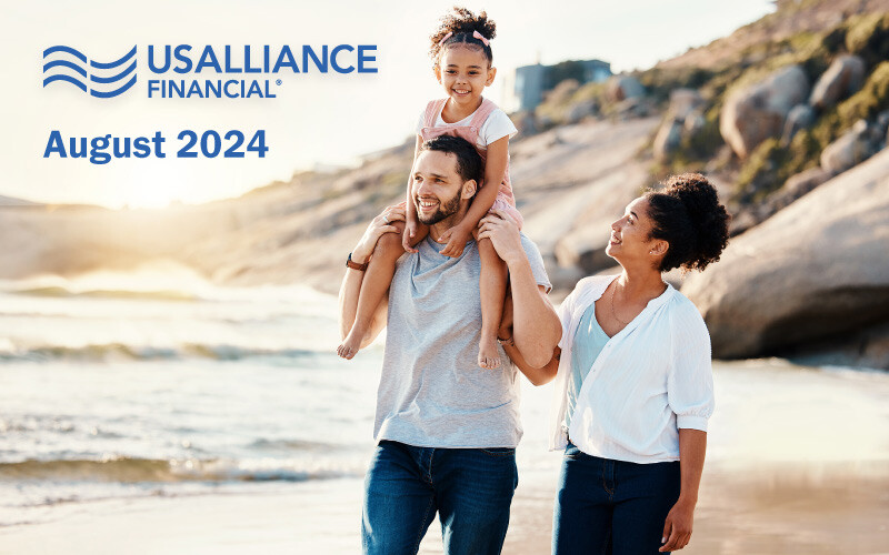 Family walking on the beach; text overlay that reads, 'USALLIANCE Financial, August 2024.'