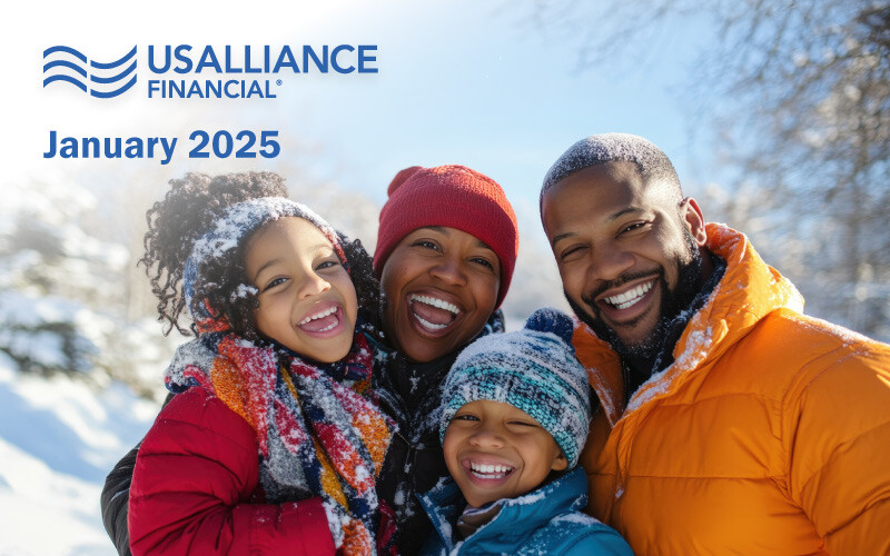 A smiling family of four outdoors in winter clothing with a snowy background.