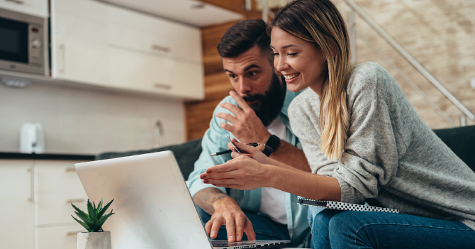 Couple viewing their finances on their laptop