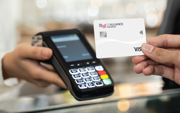 Male using his Classic Visa Card to make a purchase.