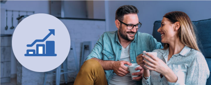 Couple having coffee in living room.