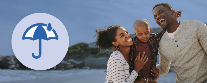 A round icon of a umbrella and rain, with a family laughing on the beach.