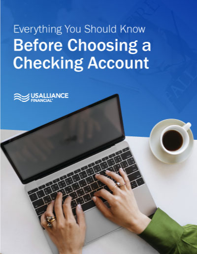 'Everything You Should Know Before Choosing a Checking Account' above an image of a person typing on a laptop with a coffee cup beside them.