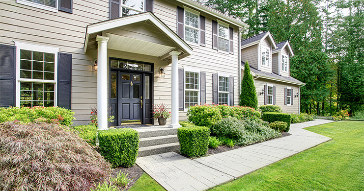 A large grand home in the summertime.