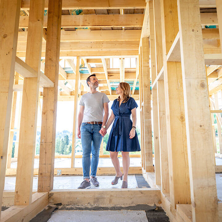 A couple walking through a construction of a home.